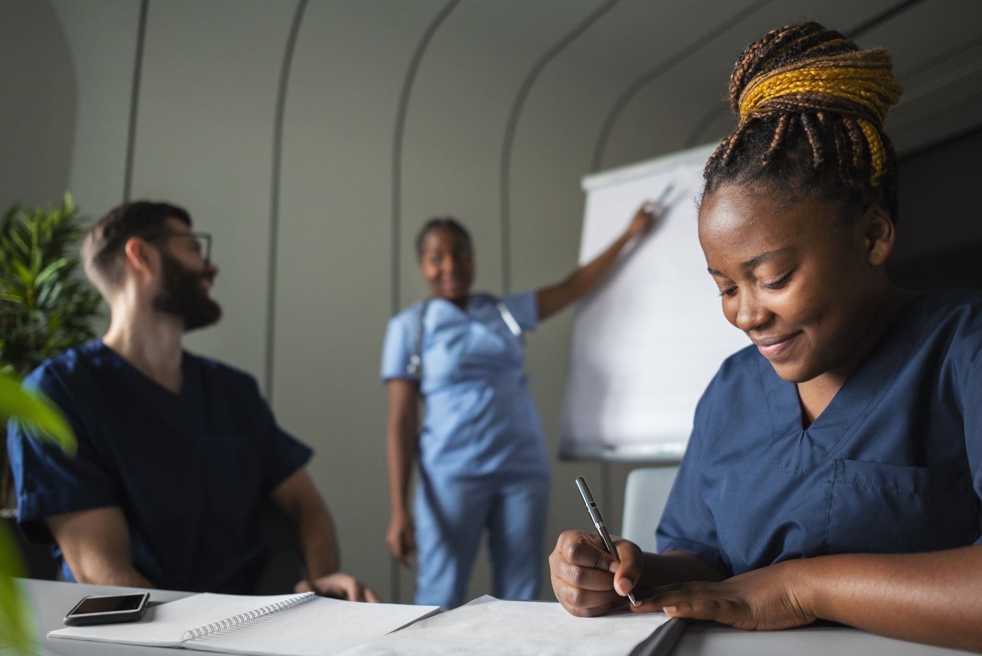 A nursing student at a desk thinking through her next step
